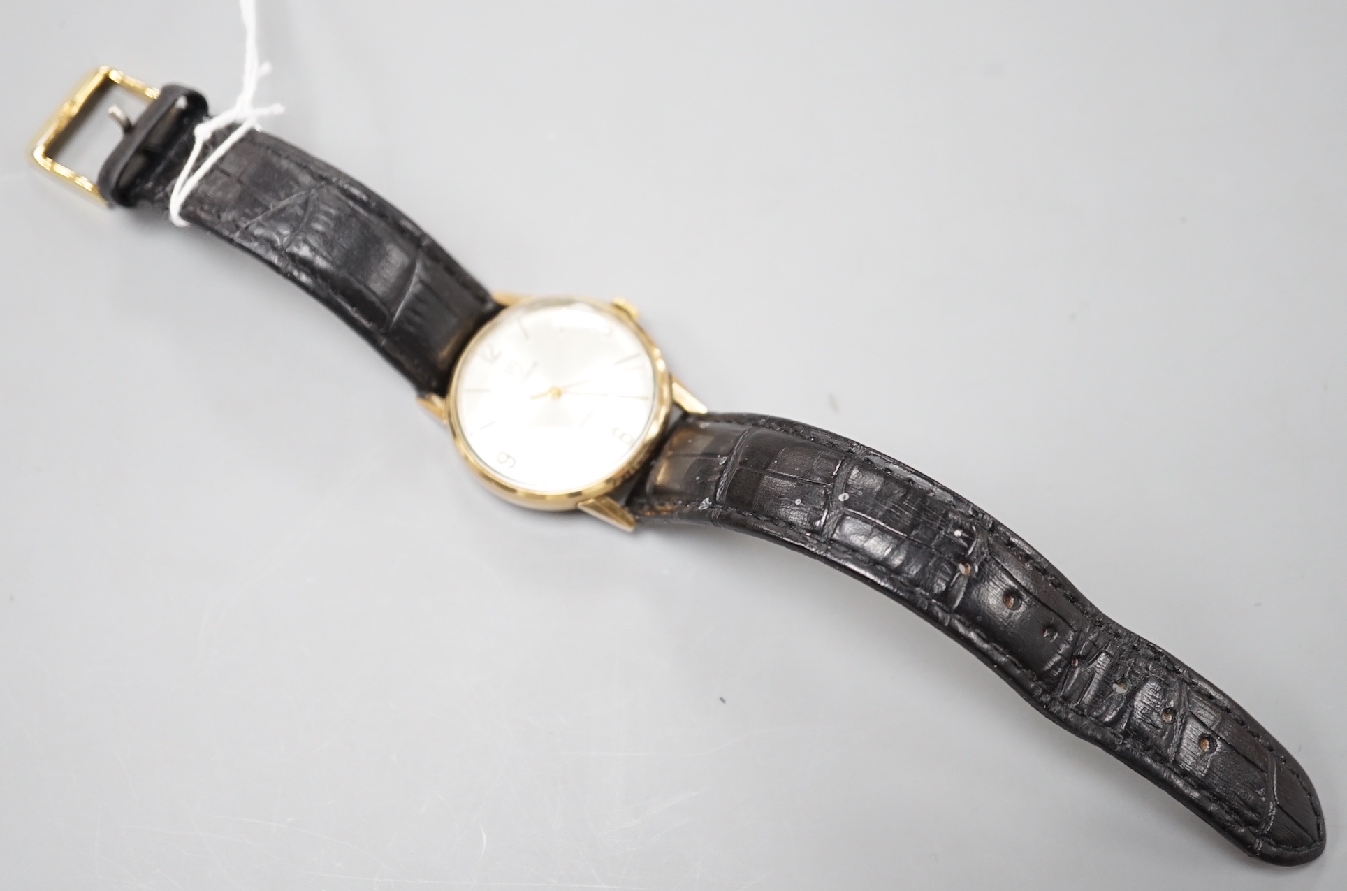 A gentleman's 1970's 9ct gold Tudor manual wind shock-resisting wrist watch, on a black leather strap, case diameter 33mm, with case back inscription